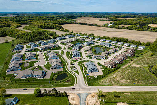 A bird's eye view of a residential area with houses and roads.