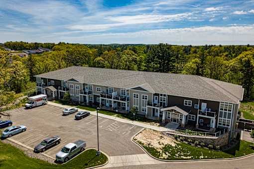 A large building with a parking lot in front of it.