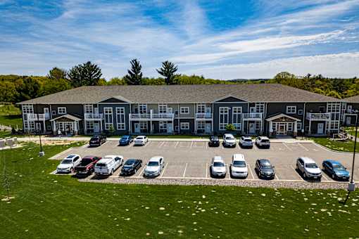 A large building with a parking lot in front of it.