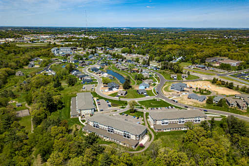A bird's eye view of a small town with a mix of residential and commercial buildings.