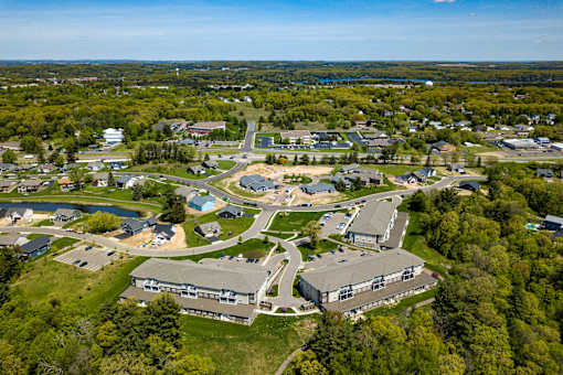 An aerial view of a small town with a mix of residential and commercial buildings.