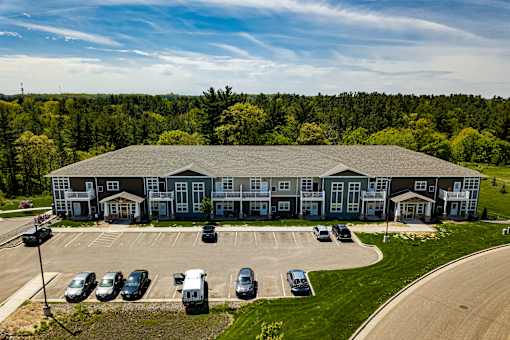 A large building with a parking lot in front of it.