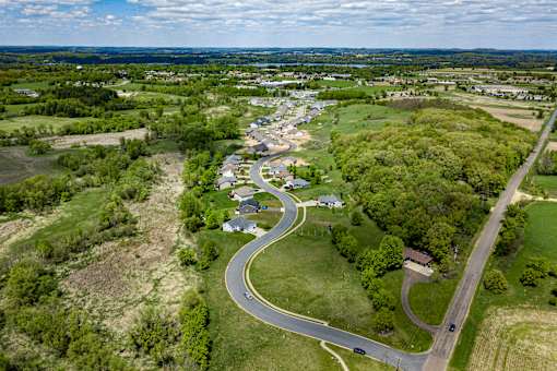 A small town with a curvy road in the foreground.