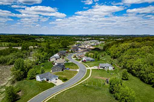 A small town with a curved road in the foreground.