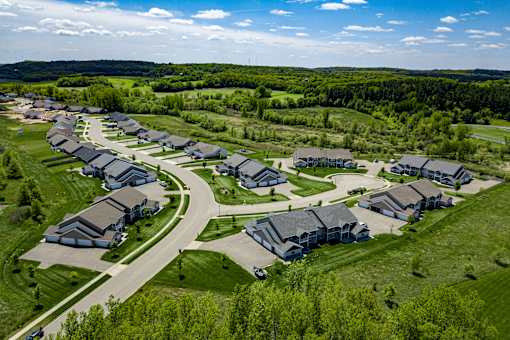 A bird's eye view of a residential area with houses and a road.
