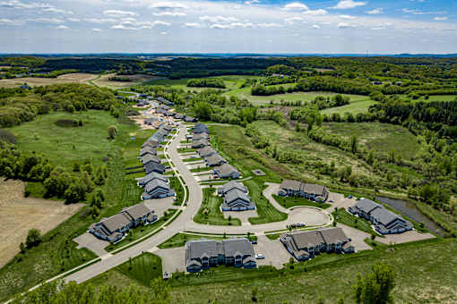 A bird's eye view of a residential area with houses and greenery.