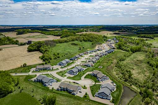 A bird's eye view of a residential area with houses and a river.