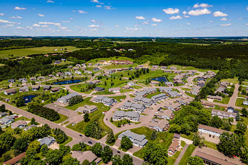 A bird's eye view of a residential area with houses and roads.