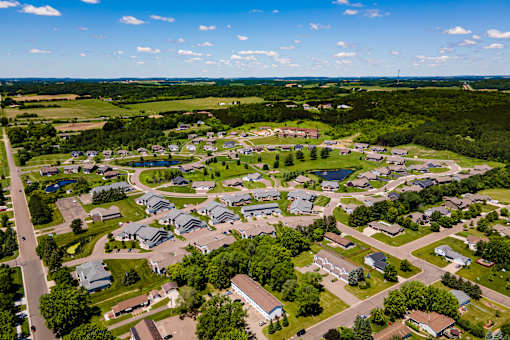 A bird's eye view of a residential neighborhood with houses and greenery.