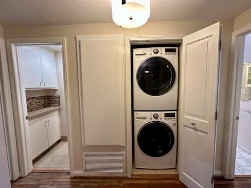 A white washer and dryer in a small laundry room.
