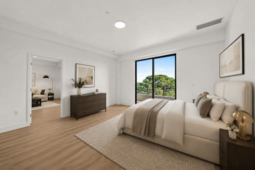 A bedroom with a large bed and a dresser with a mirror.