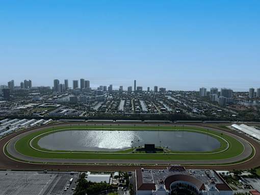 A view of a race track with a city skyline in the background.