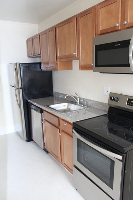 a kitchen with a stove a sink and a refrigerator