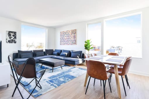 a living room with white walls and hardwood floors