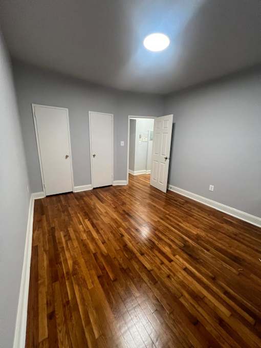 A room with wooden floors and white walls.