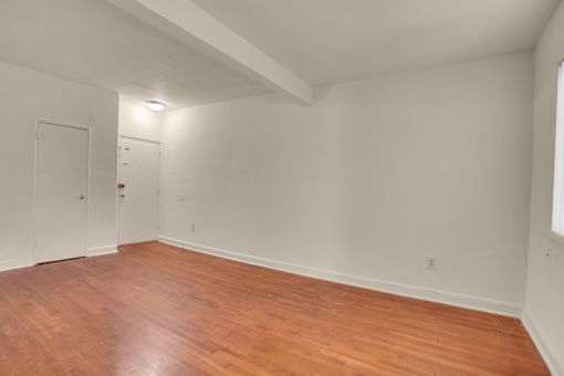 A room with wooden floors and white walls.