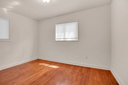 A room with wooden floors and a window.