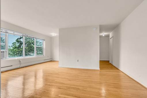 A room with wooden floors and white walls.