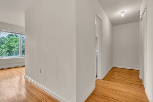 A room with wooden floors and white walls.