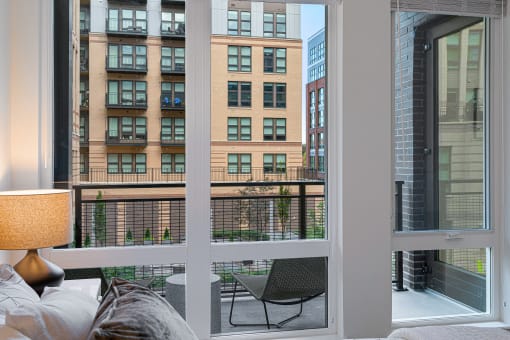 a living room with a balcony and a view of the city