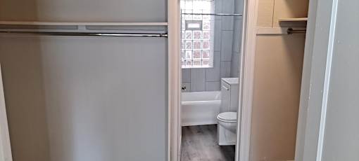 A white toilet sits next to a sink in a small bathroom.