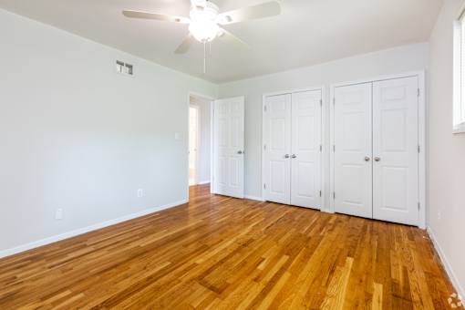 A room with wooden floors and white walls.