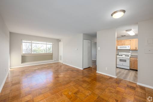 A room with wooden flooring and a window.