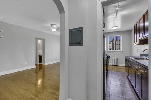 a kitchen and living room with wood floors and white walls