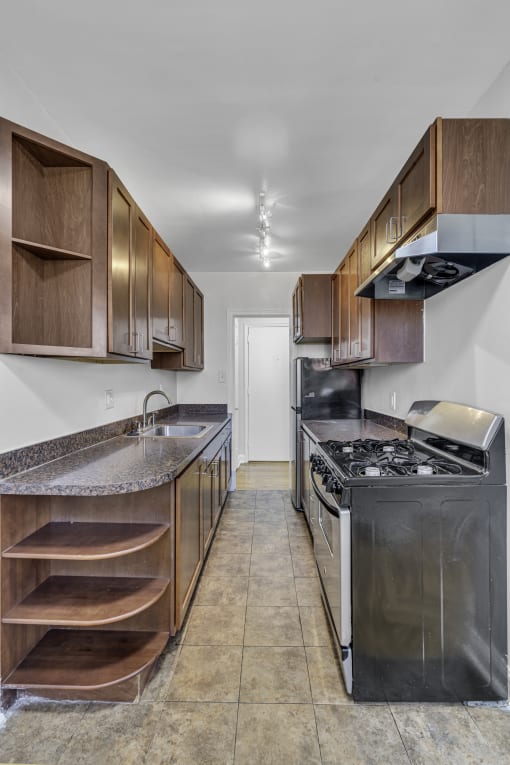a kitchen with stainless steel appliances and wooden cabinets