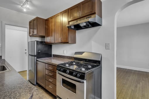a kitchen with stainless steel appliances and wooden cabinets