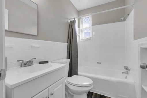 a bathroom with a toilet sink and a shower