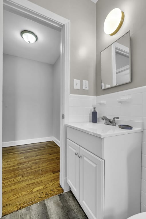 a small bathroom with a sink and a mirror
