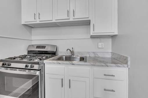 A modern kitchen with a stove and sink.