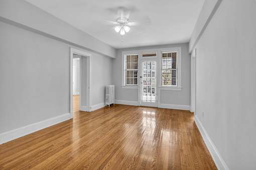 A room with wooden floors and white walls.