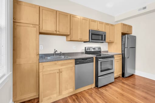 a kitchen with wooden cabinets and stainless steel appliances