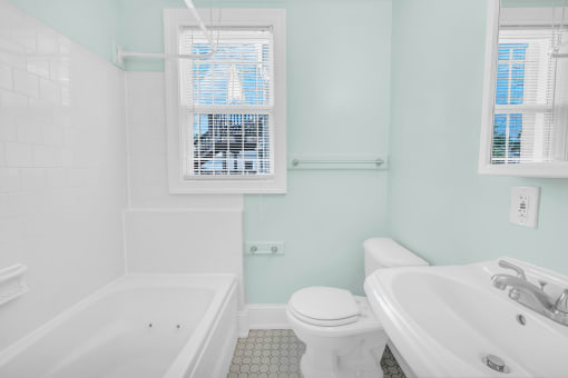 a bathroom with a sink toilet and a tub
