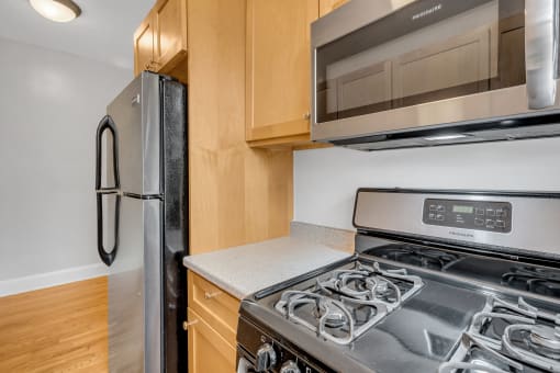a kitchen with a stove and a microwave and a refrigerator