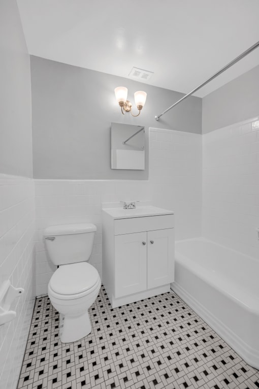a white bathroom with a toilet and a sink