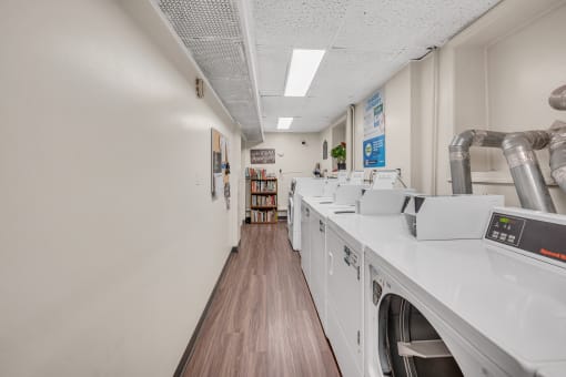 laundry room with washers and dryers and a wood floor