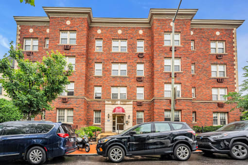 a large brick building with cars parked in front of it