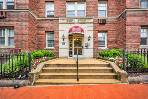 the front of a brick building with steps and a door
