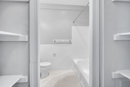 a bathroom with a toilet and a tub and a shower