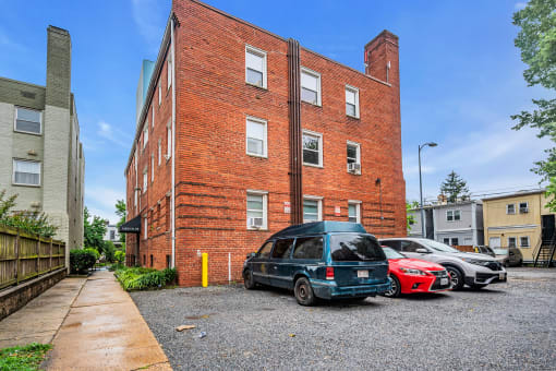 an old brick building with cars parked in front of it