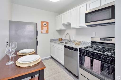 A kitchen with a stove, oven, and refrigerator.