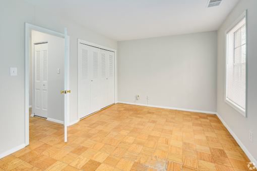 A room with a wooden floor and white walls.