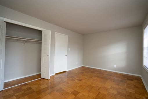 a living room with a wood floor and a closet