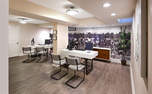 an open office with tables and chairs and a wall mural