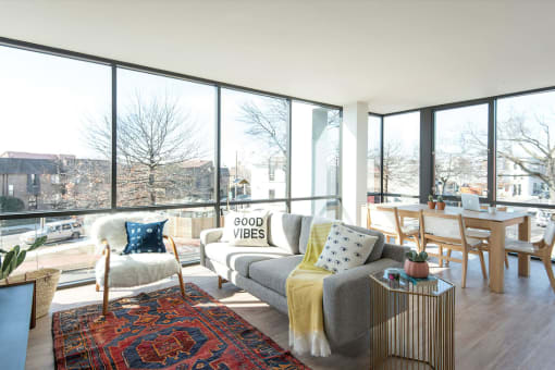 a living room with a large window and a view of a city