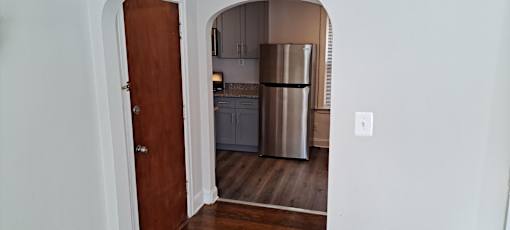 A kitchen with white cabinets and a white stove.