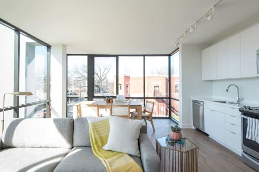 a living room with a couch a table and a window